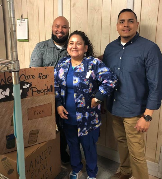 Three dental team members delivering food donations