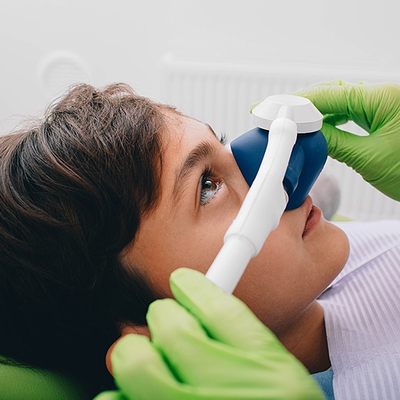 Young patient receiving nitrous oxide dental sedation treatment