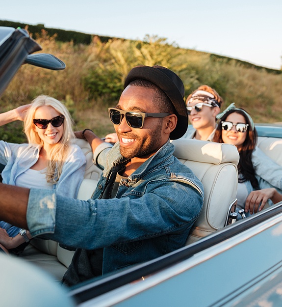 Patient smiling with friends in car on road trip