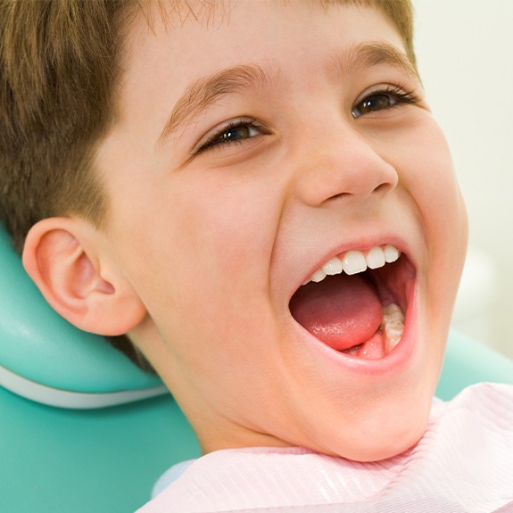 Young boy laughing after receiving fluoride treatment