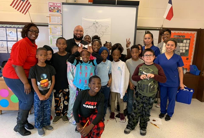 Dental team members volunteering at a school