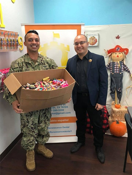 Dentist donating candy to military service member