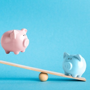 Piggy banks on balance scale