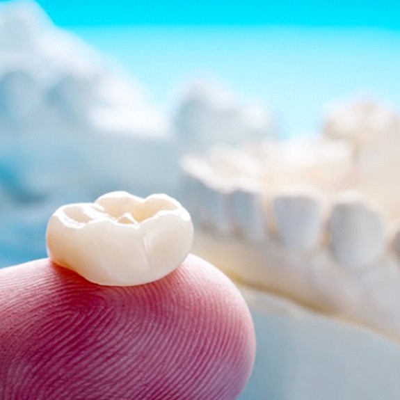 dental crown on a person’s finger
