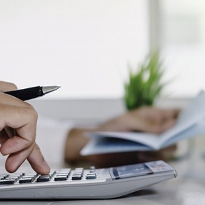 Man calculating cost of dentures in Fort Worth