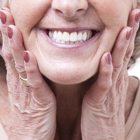 Closeup of senior woman smiling with dentures in Fort Worth