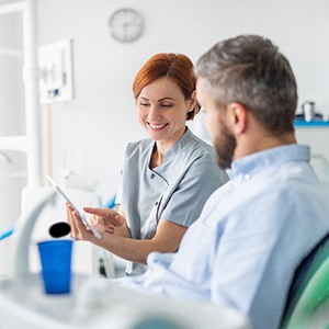 a dentist discussing dentures with a patient in Fort Worth