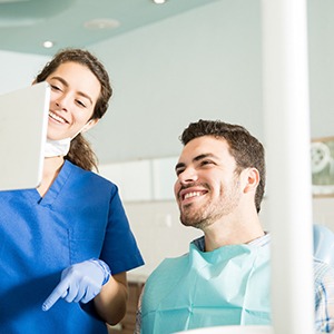 a patient smiling with dentures in Fort Worth