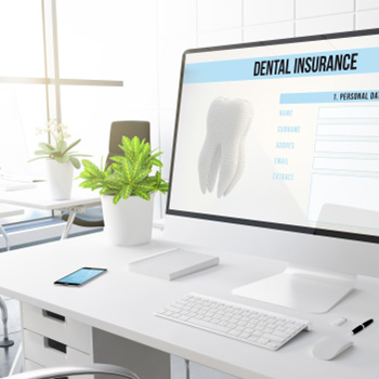 Dental insurance form on desktop in office