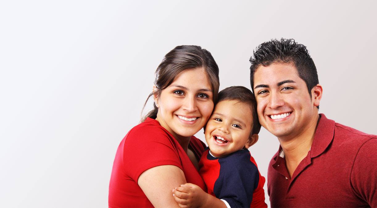 Family of three with healthy smiles thanks to family dentistry