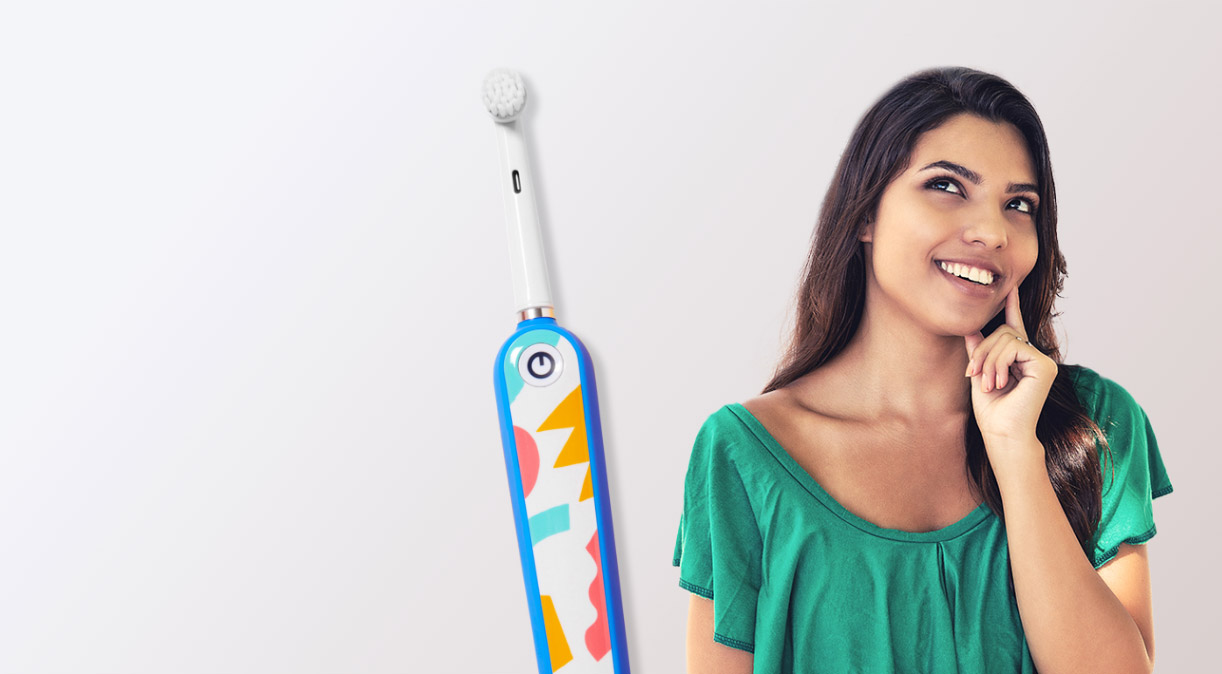 Woman with healthy smile and electric toothbrush
