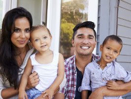 Family with two young children who have healthy smile after children's dentistry