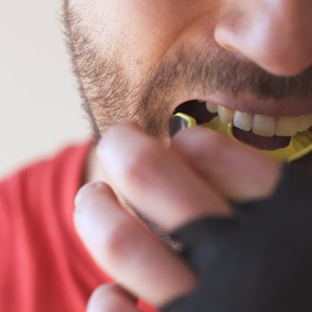 Man inserting a mouthguard