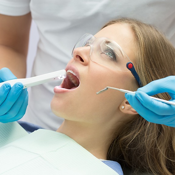 Dentist capturing images using intraoral camera