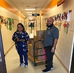 Two dental team members delivering a donation