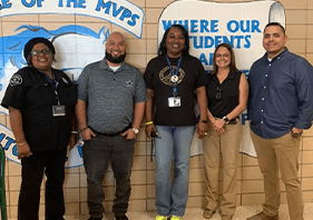 Five dental team members at community event