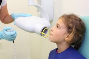 a child receiving a digital X-ray at the dentist's office
