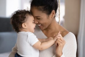 Mother smiling at child after learning about children's dentistry 