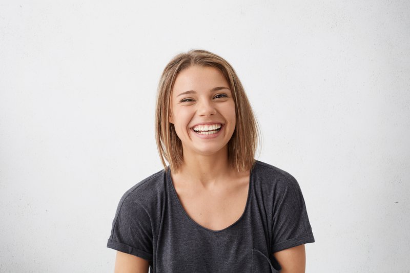 young woman smiling with small teeth