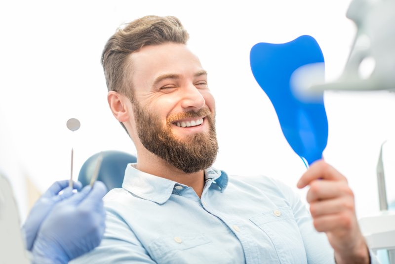 person smiling after being treated by cosmetic dentist