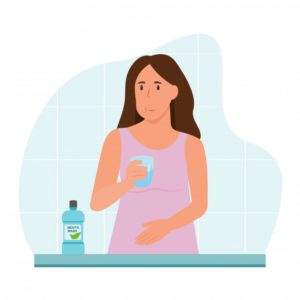 woman rinsing with mouthwash 