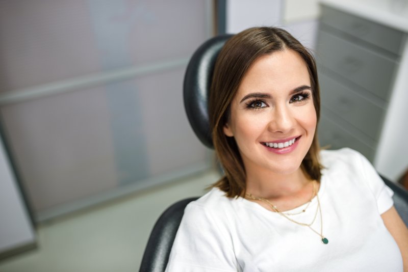 person smiling after getting porcelain veneers