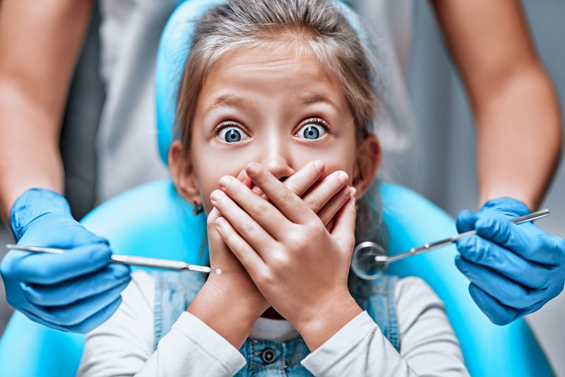 A little girl frightened by her oral health